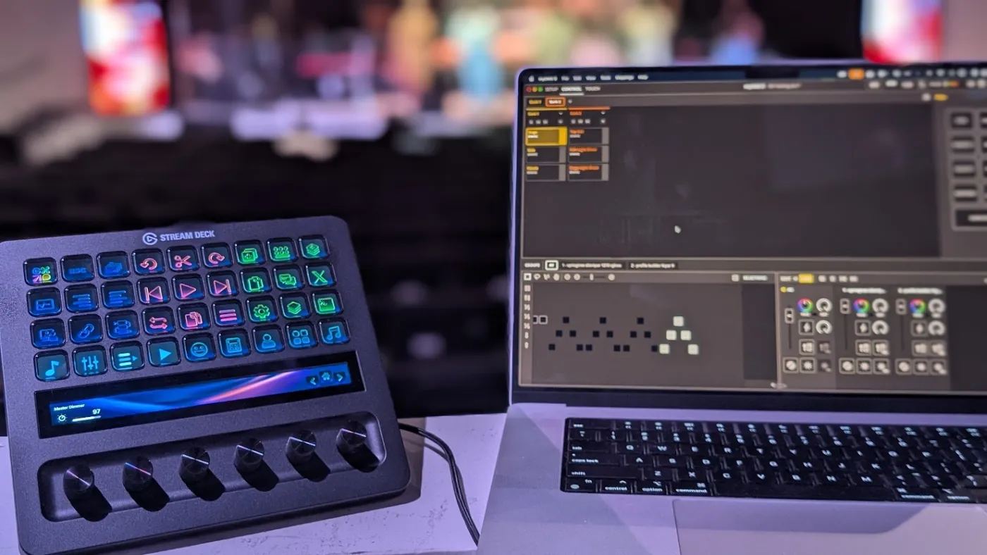 Stream Deck + beside a laptop running lighting software, with keys reflecting the software's state